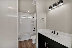 Main floor, Full bathroom featuring shower / tub  combination, vanity, and recessed lighting