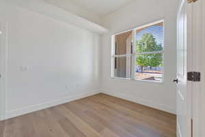 Office/bedroom with light hardwood / wood-style flooring