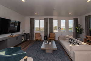 Pics are of model home.Living room featuring dark hardwood / wood-style floors and a wealth of natural light