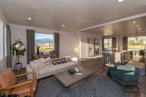 Pics are of model home.Living room with a mountain view, a wealth of natural light, dark wood-type flooring, and sink