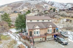 Rear view of house with a mountain view and a garage