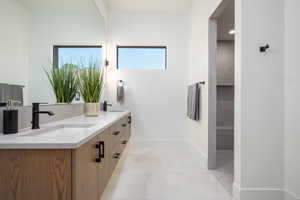 Bathroom featuring vanity, tile patterned floors, and walk in shower