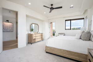 Carpeted bedroom featuring ceiling fan and access to exterior