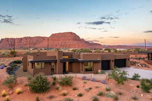 Pueblo revival-style home featuring a mountain view and a garage