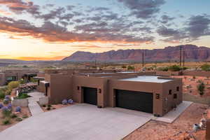 View of front of property featuring a mountain view and a garage