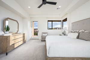 Carpeted bedroom featuring access to exterior and ceiling fan