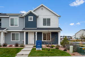 View of property with a front yard