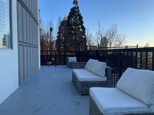 Patio terrace at dusk featuring an outdoor living space