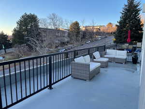 Balcony at dusk with an outdoor living space and a patio area