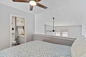 Bedroom featuring a textured ceiling, ensuite bath, and ceiling fan