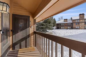 View of snow covered back of property