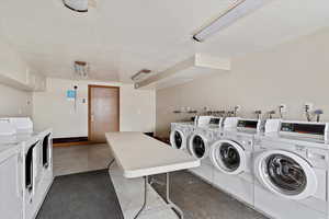 Laundry area featuring a textured ceiling and separate washer and dryer