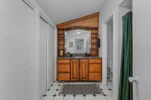 Bathroom featuring vanity, toilet, walk in shower, and a textured ceiling