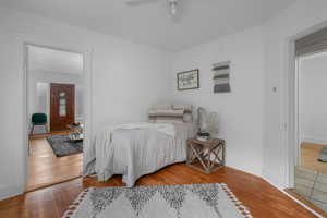 Bedroom with ceiling fan and hardwood / wood-style flooring