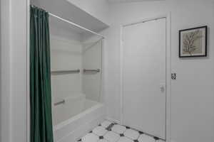 Bathroom with shower / bathtub combination with curtain