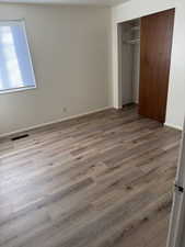 Unfurnished bedroom featuring a closet and light hardwood / wood-style flooring