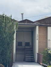 View of exterior entry featuring brick siding