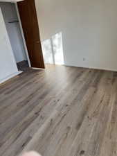 Unfurnished bedroom with hardwood / wood-style flooring and a closet