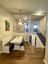 Dining area with beamed ceiling, ceiling fan, and dark hardwood / wood-style flooring