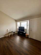 Interior space with dark hardwood / wood-style floors