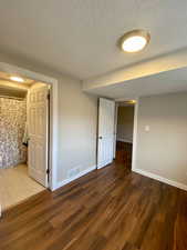 Spare room with wood-type flooring and a textured ceiling