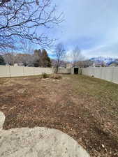 View of yard featuring a mountain view and a storage shed