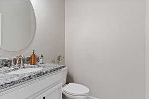 Half bath featuring toilet and vanity