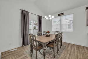 Dining room w/ vaulted ceiling w/ LVP style flooring
