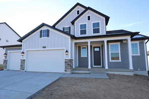 View of front facade with a garage and covered porch