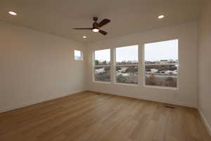 Unfurnished room featuring ceiling fan and light wood-type flooring