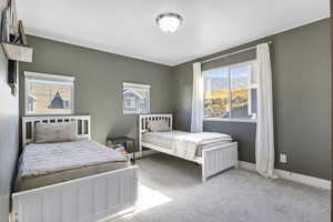 Bedroom featuring light colored carpet