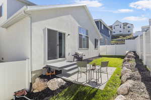 Back of property featuring a patio area and a yard