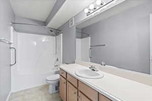 Full bathroom with vanity,  tub/shower combination, and toilet