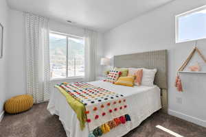 Bedroom featuring dark colored carpet