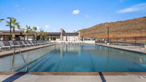 View of pool with a mountain view and a patio