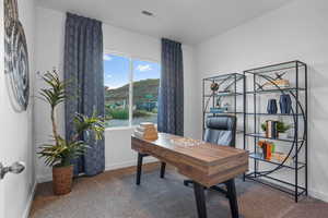 Carpeted office space featuring a mountain view