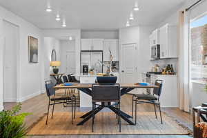 Dining room with light hardwood / wood-style flooring