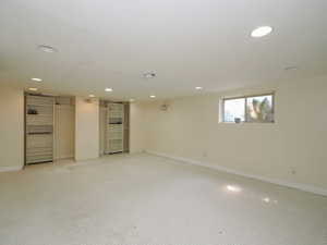 Basement featuring light colored carpet