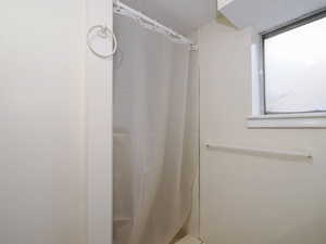 Bathroom featuring a shower with curtain