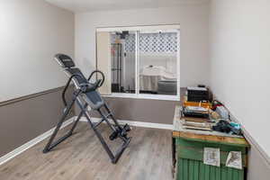 Exercise area featuring hardwood / wood-style floors and a textured ceiling