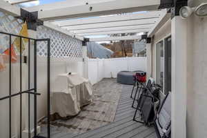 Deck with a pergola and area for grilling