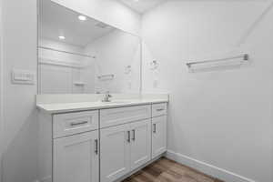 Bathroom with hardwood / wood-style floors and vanity