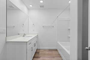 Bathroom with hardwood / wood-style floors and vanity