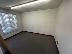 Empty room featuring a textured ceiling