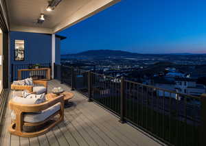 Balcony at dusk featuring a mountain view