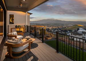 Balcony at dusk with a mountain view and an outdoor hangout area