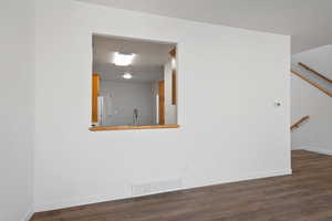 Spare room featuring dark hardwood / wood-style flooring and sink