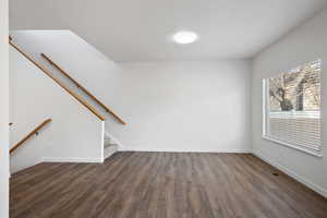 Spare room featuring dark hardwood / wood-style floors