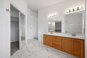 Bathroom featuring vanity and walk in shower