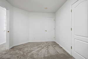 Unfurnished bedroom with carpet flooring